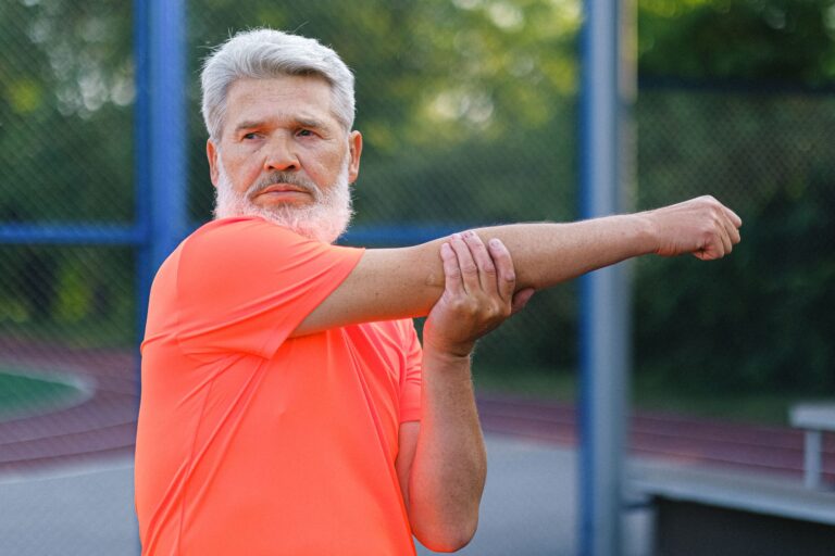 Older man stretching in a park, background image for what diabetic neuropathy is